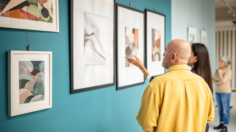 People looking at pieces of art