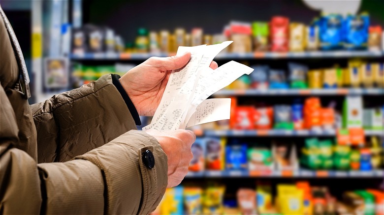 Person checking grocery receipts