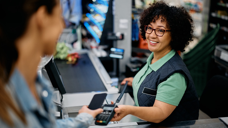 customer paying at grocery store