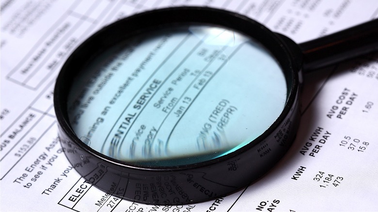 magnifying glass on electric bill