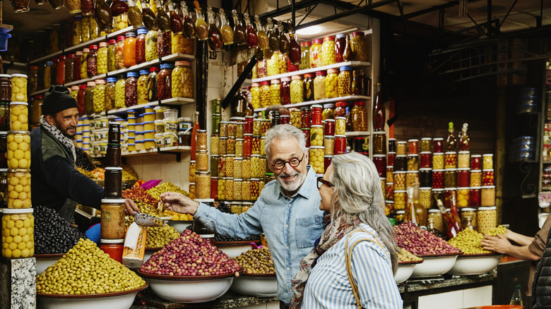 A smiling senior couple exploring a market in Morocco