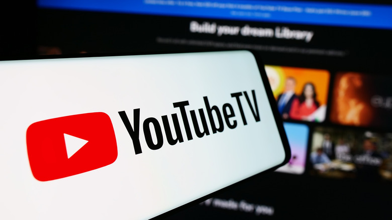 A fish-eye view of a phone with the YouTube TV screen pulled up, in front of YouTube TV on a TV screen.