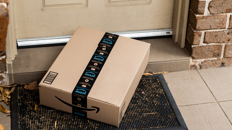 An Amazon box delivered to a front door