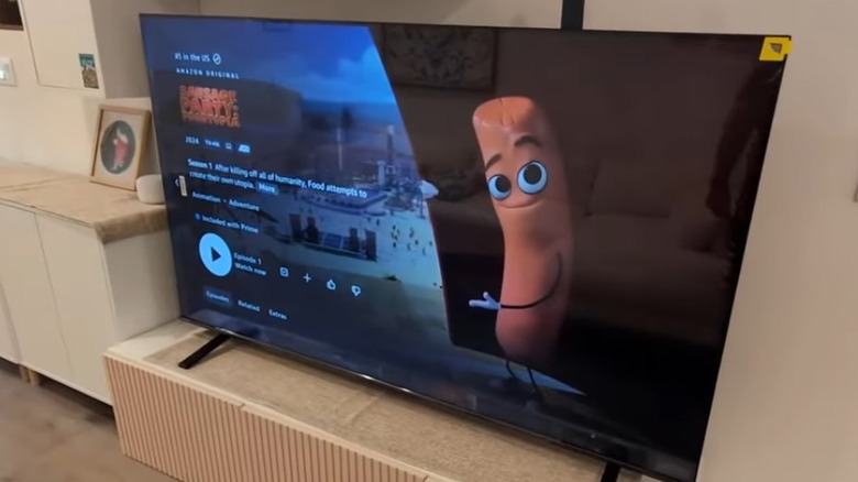 A Toshiba 75 inch TV with Sausage Party on character on screen