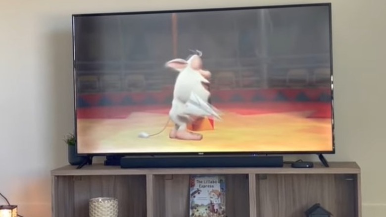 RCA TV with blurred cartoon animal on screen in living room