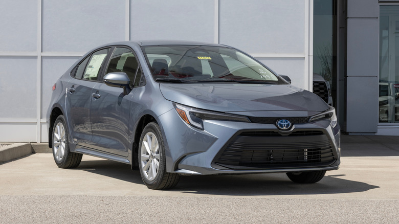 Toyota Corolla Hybrid LE AWD Sedan at a dealership.
