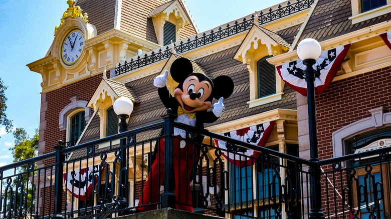 Mickey Mouse in front of the train station in Disneyland park California