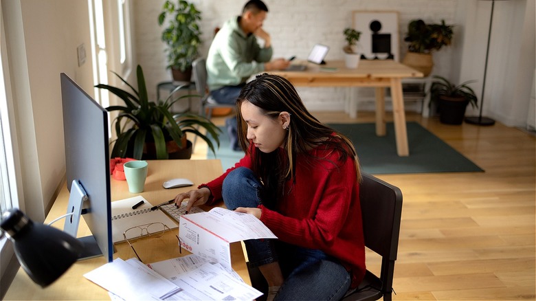 Person calculating bills at home