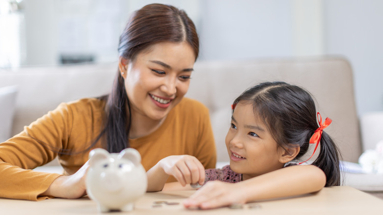 A woman teaching a child to manage finances