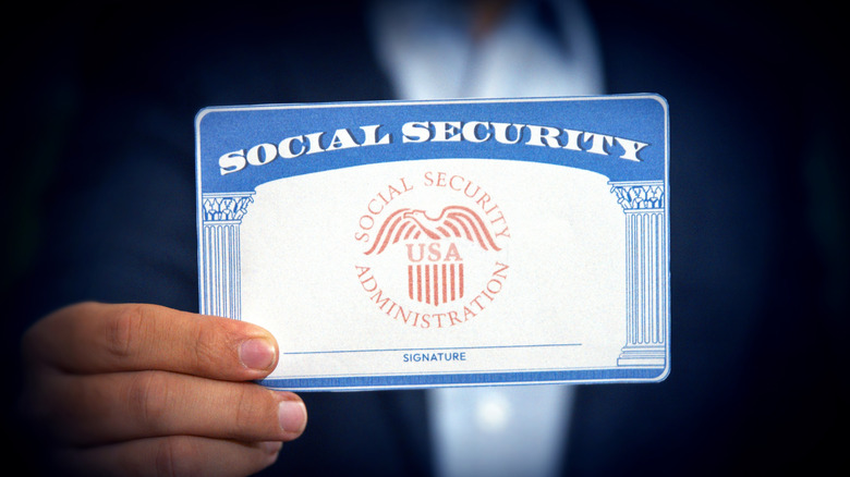 Man showing Social Security Card, Close up shot with blur backdrop