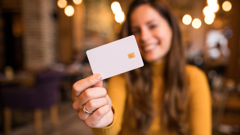 A woman holding a credit card