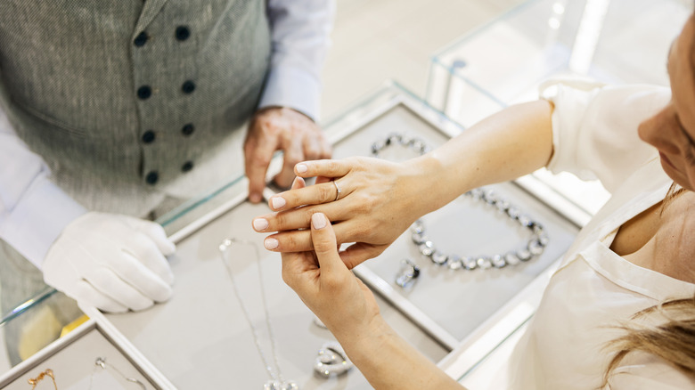 A woman wearing a ring in a jewelry store