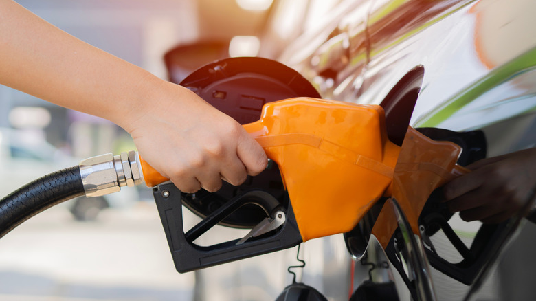 Hand of a person filling a vehicle up with gas