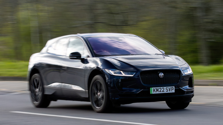 A Jaguar I-Pace driving down a road in Great Britain.