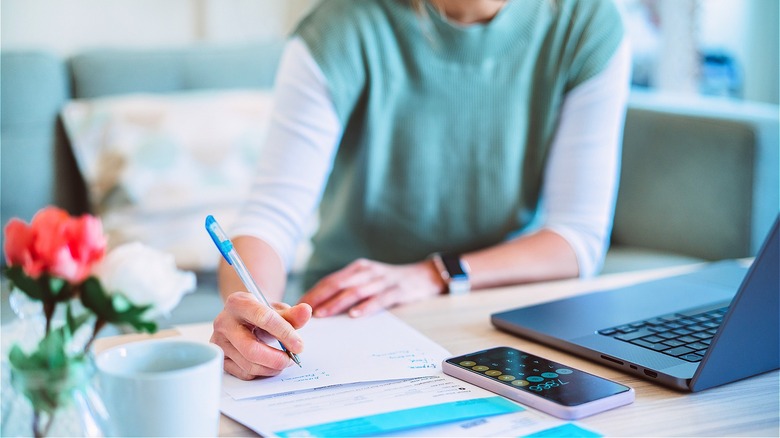 Person calculating finances at desk