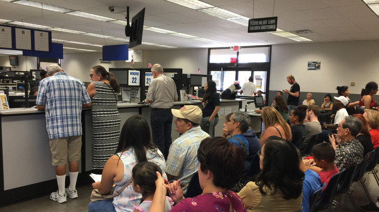 People waiting in a DMV office