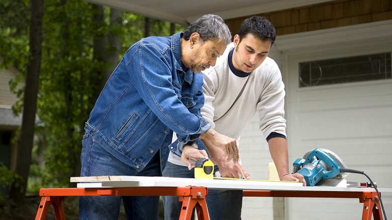 Two people working construction project